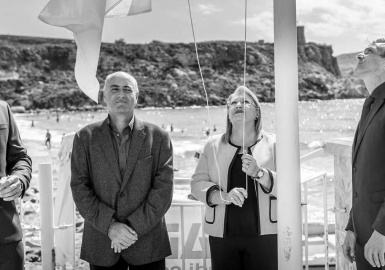 H.E. Marie-Louise Coleiro Preca raising the White Flag at the Golden Bay, campaign kick-off 